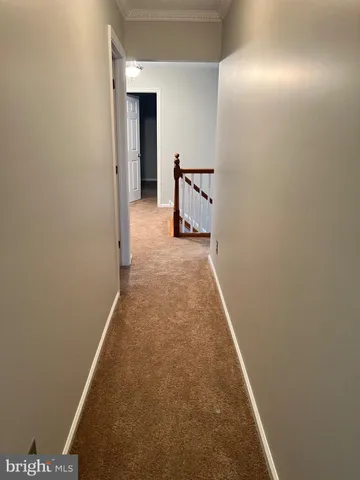 an empty room with closet and entryway