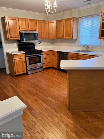 a kitchen with stainless steel appliances a stove a sink and a microwave