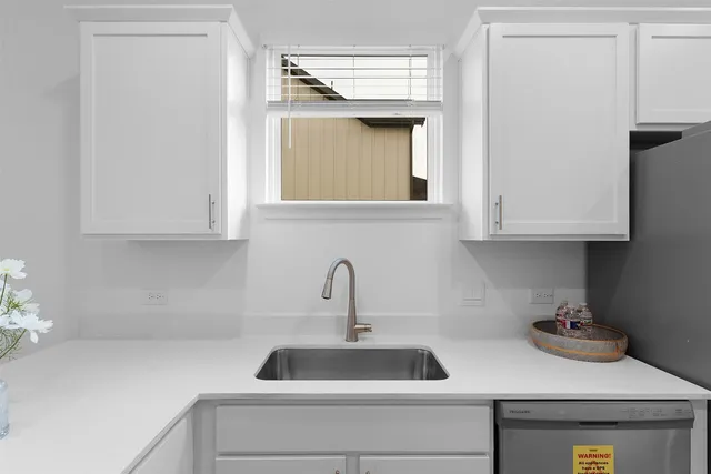 a kitchen with white cabinets and a stove