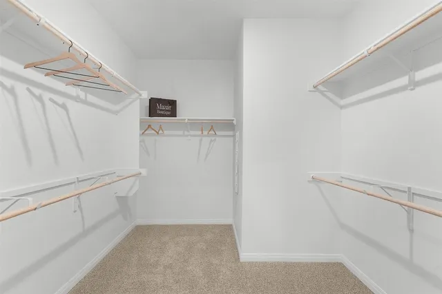 a kitchen with white cabinets and sink