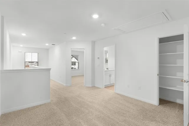 a view of a big room with kitchen and chandelier