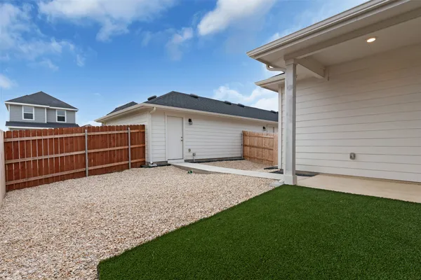 a view of a house with wooden fence
