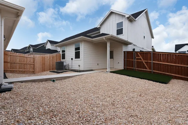 a view of a house with wooden fence