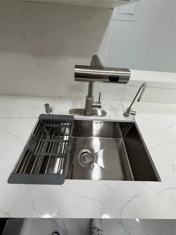 a kitchen with stainless steel appliances granite countertop a sink and a stove