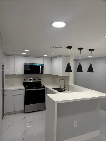 a kitchen with a stove and a sink