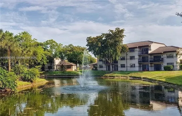 a blue swimming pool with outdoor seating and yard