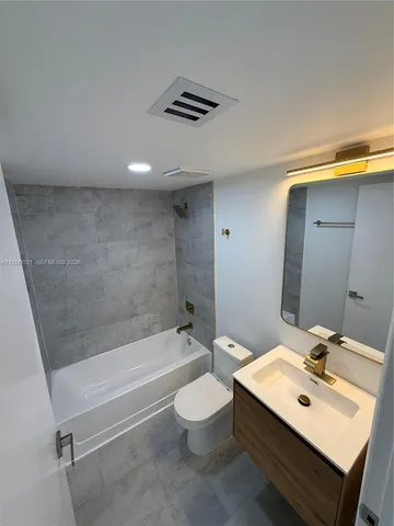 a bathroom with a sink toilet a mirror and shower