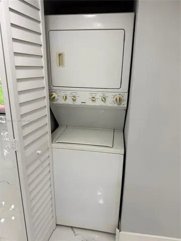 a dining area with furniture window and wooden floor