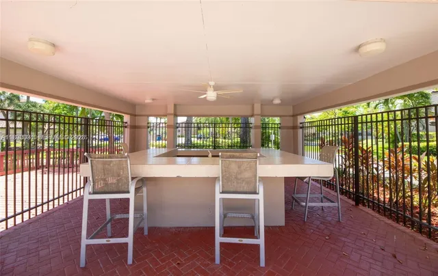 an outdoor space with patio and white umbrellas