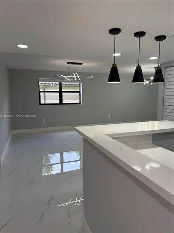 a view of a hallway with of the kitchen