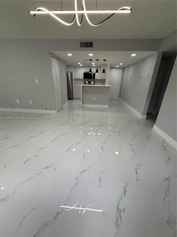 a view of a kitchen with a sink and cabinets