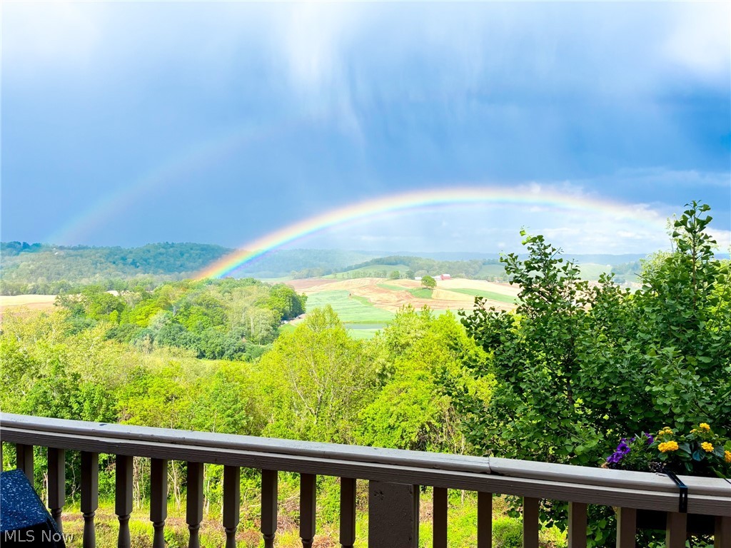 1602 Glendale Road, Unit 3 Marietta, OH 45750 - Photo 49 of 49 Expansive natural scenery featuring a vibrant rainbow arching over distant fields and lush tree lines