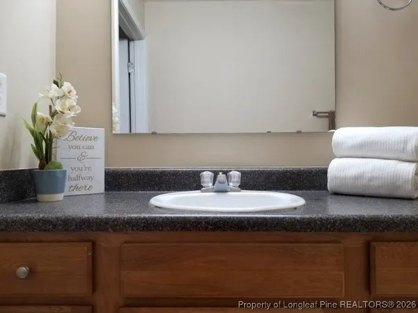 a bathroom with a sink granite and a mirror