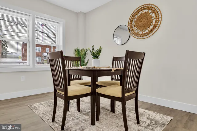 a view of a dining room with furniture and a window