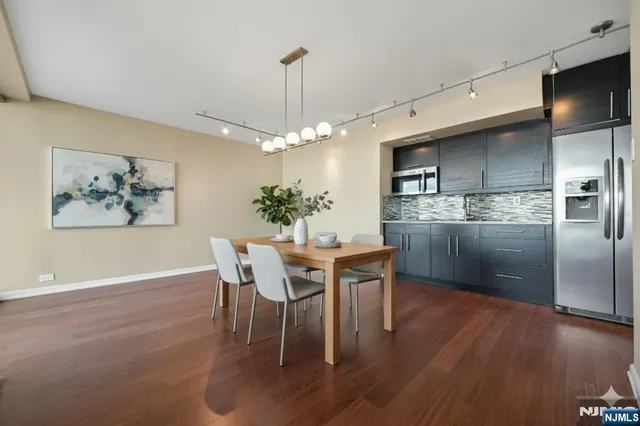 a bathroom with a granite countertop sink and a shower
