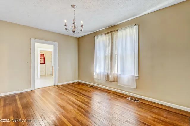 a bathroom with a granite countertop sink a mirror and a shower