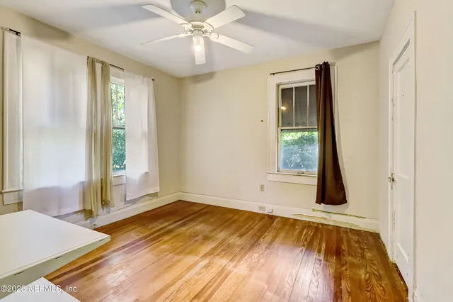 a view of an empty room and wooden floor