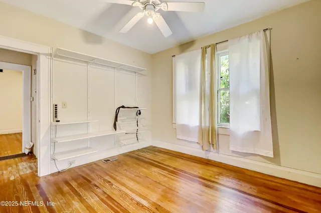 an empty room with windows fireplace and windows