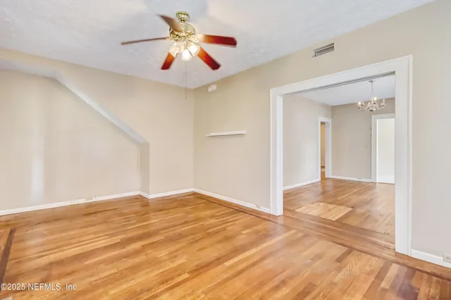 wooden floor in an empty room with a window