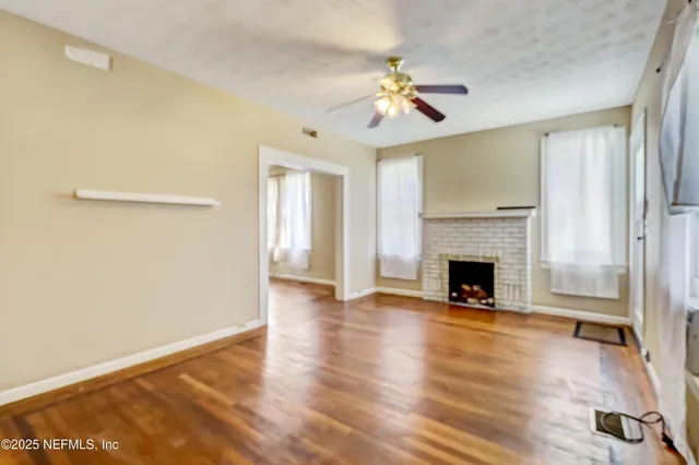 a view of a room with wooden floor and chandelier