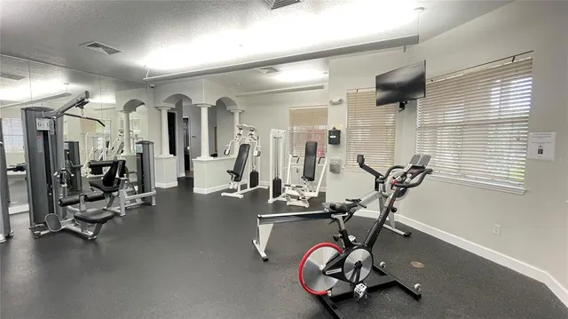 a room with gym equipment and large mirror