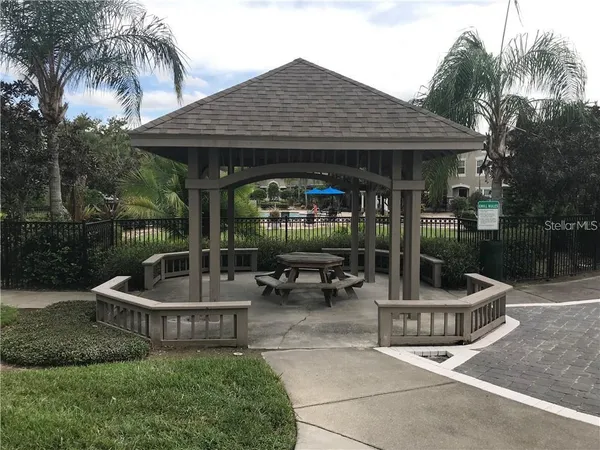 a view of a chair and table in backyard