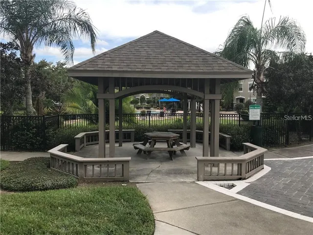 a view of a chair and table in backyard