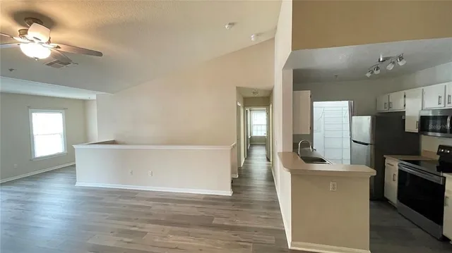 a view of kitchen with cabinets and wooden floor