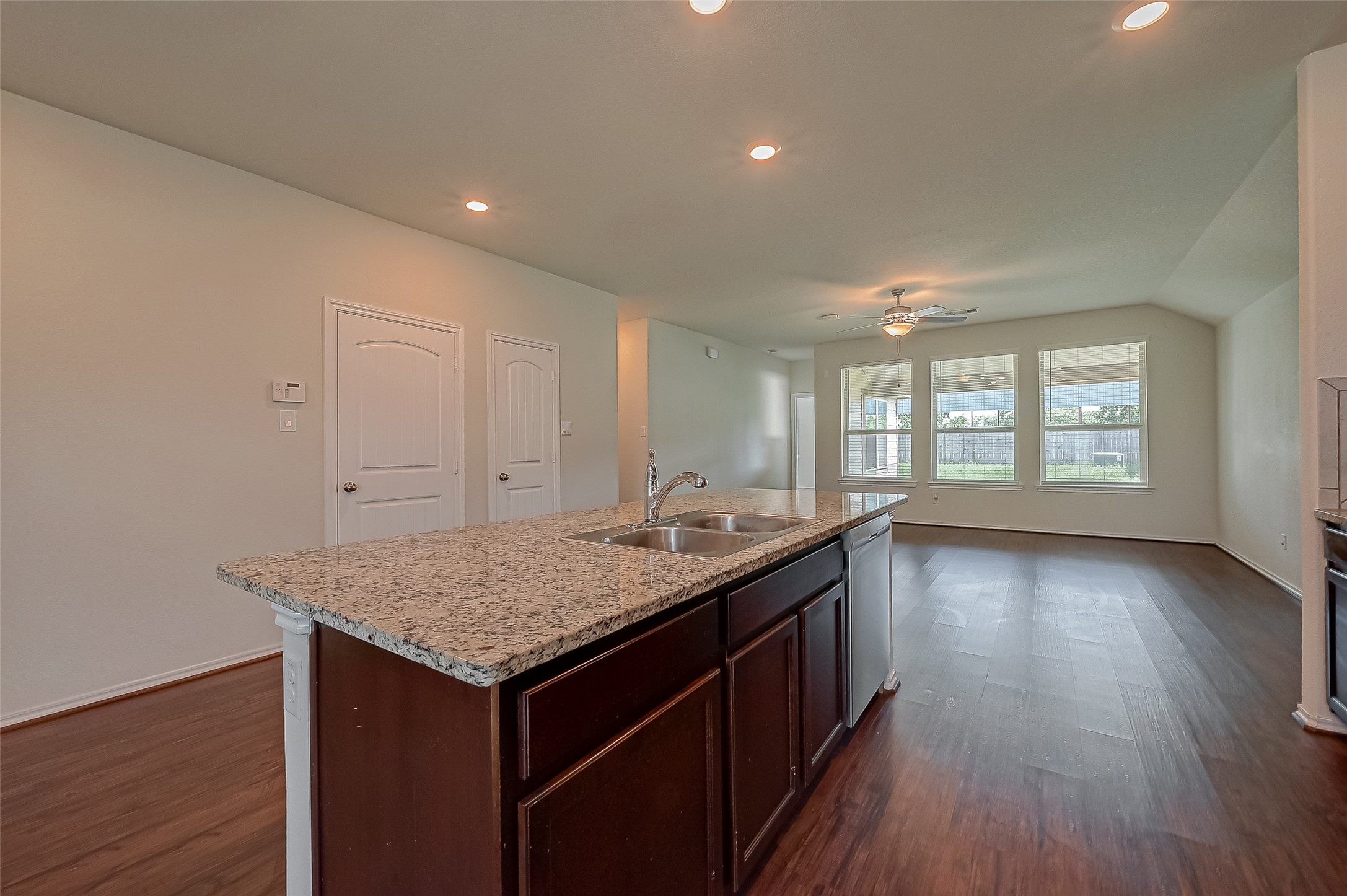 25911 Rustical Road Katy, TX 77493 - Photo 12 of 40 an empty room with wooden floor and a window