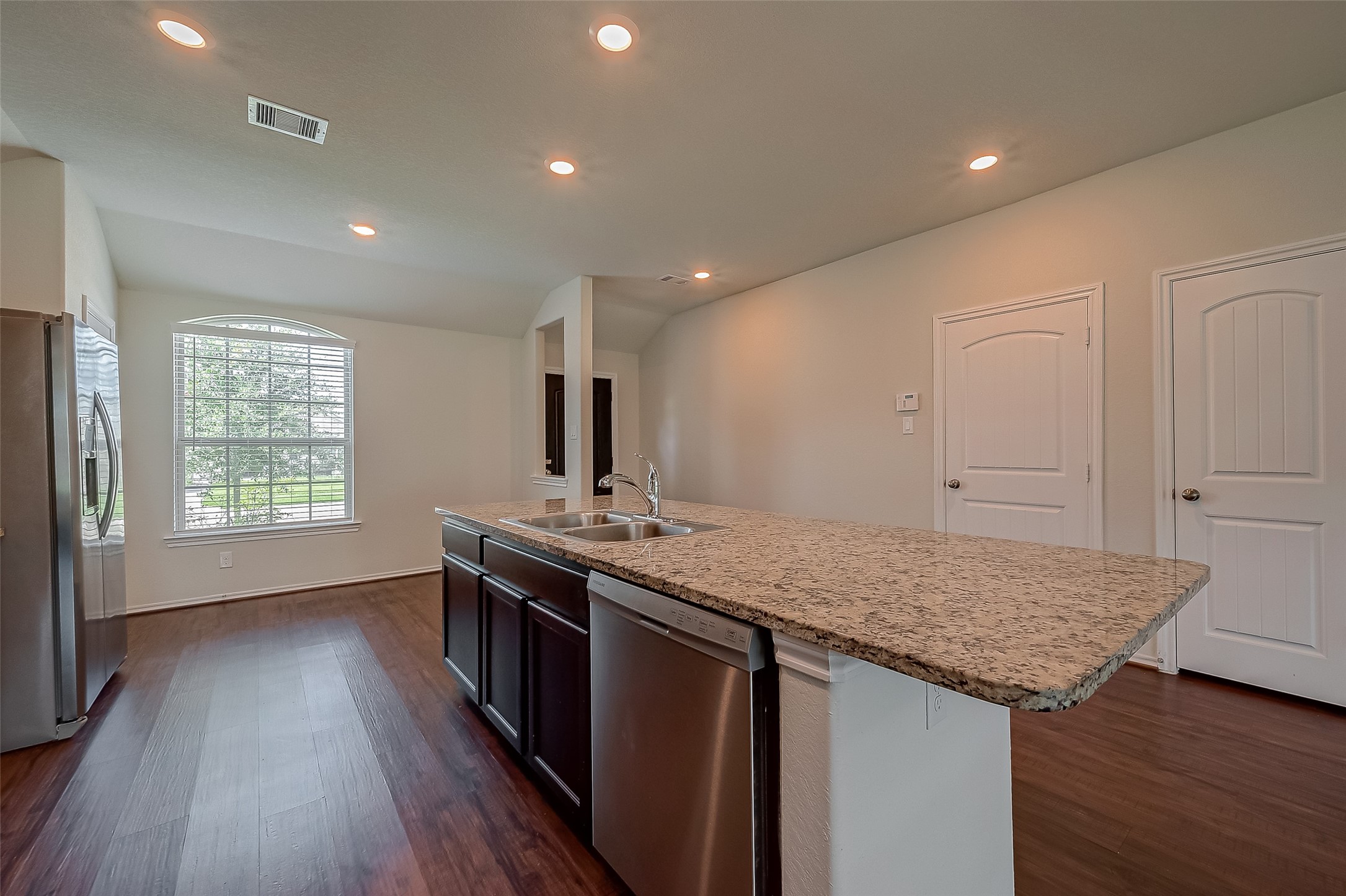 25911 Rustical Road Katy, TX 77493 - Photo 14 of 40 a kitchen with granite countertop sink stove and cabinets