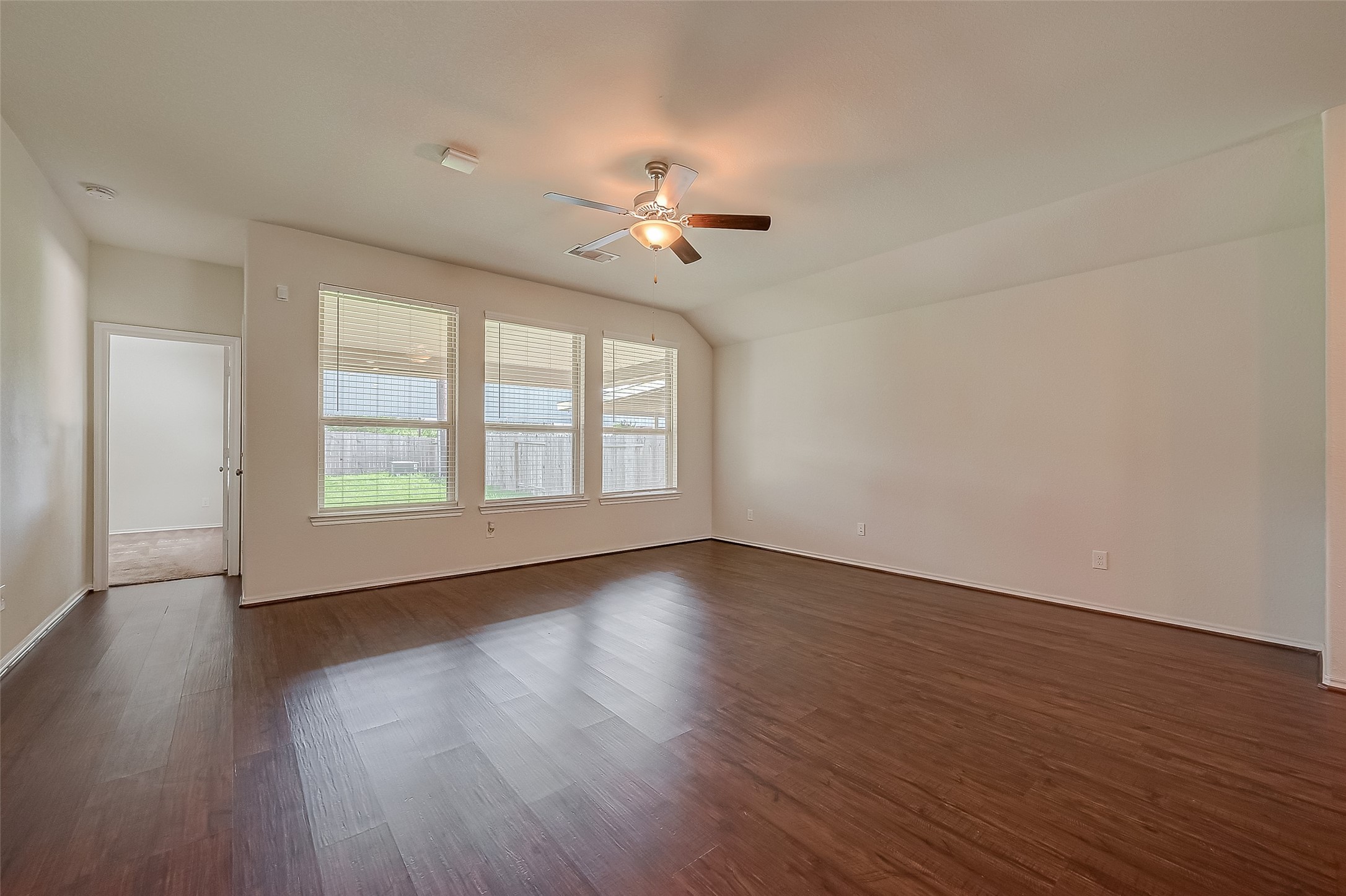 25911 Rustical Road Katy, TX 77493 - Photo 17 of 40 a view of empty room with wooden floor and fan