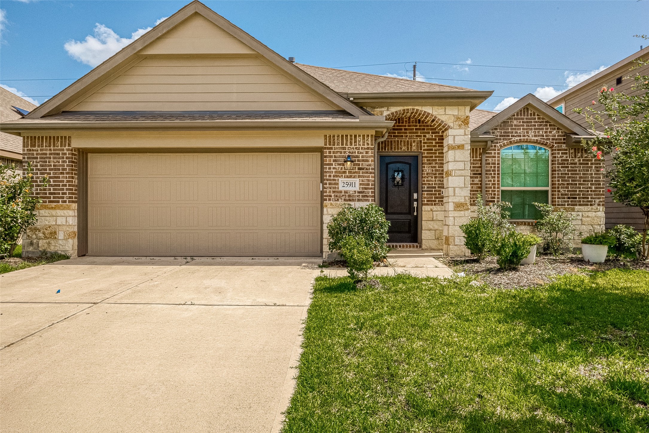 25911 Rustical Road Katy, TX 77493 - Photo 2 of 40 a front view of a house with garden