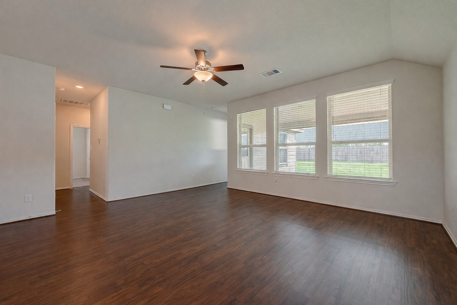 25911 Rustical Road Katy, TX 77493 - Photo 21 of 40 a view of an empty room with wooden floor and a window