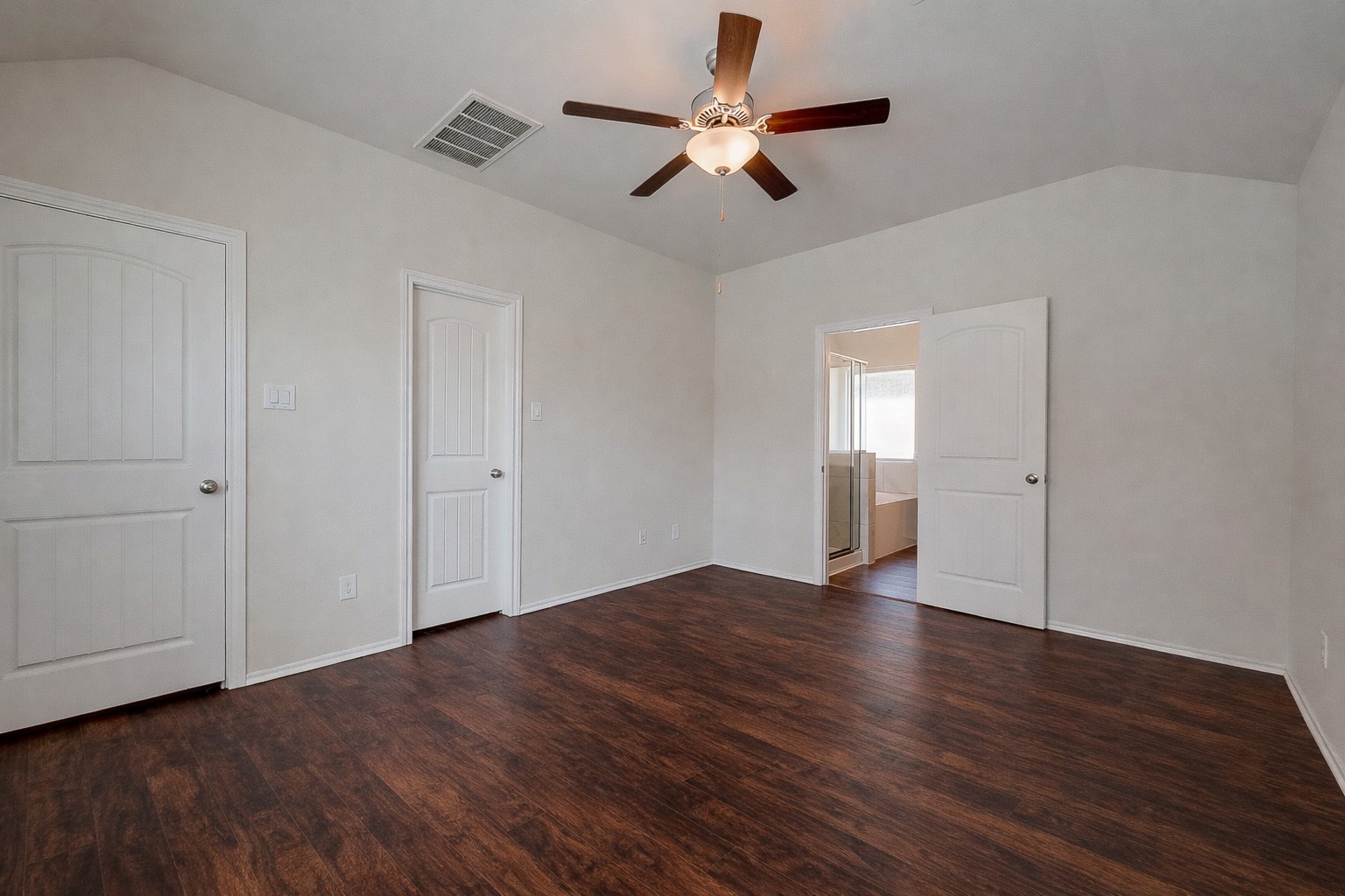 25911 Rustical Road Katy, TX 77493 - Photo 22 of 40 an empty room with wooden floor chandelier fan and windows