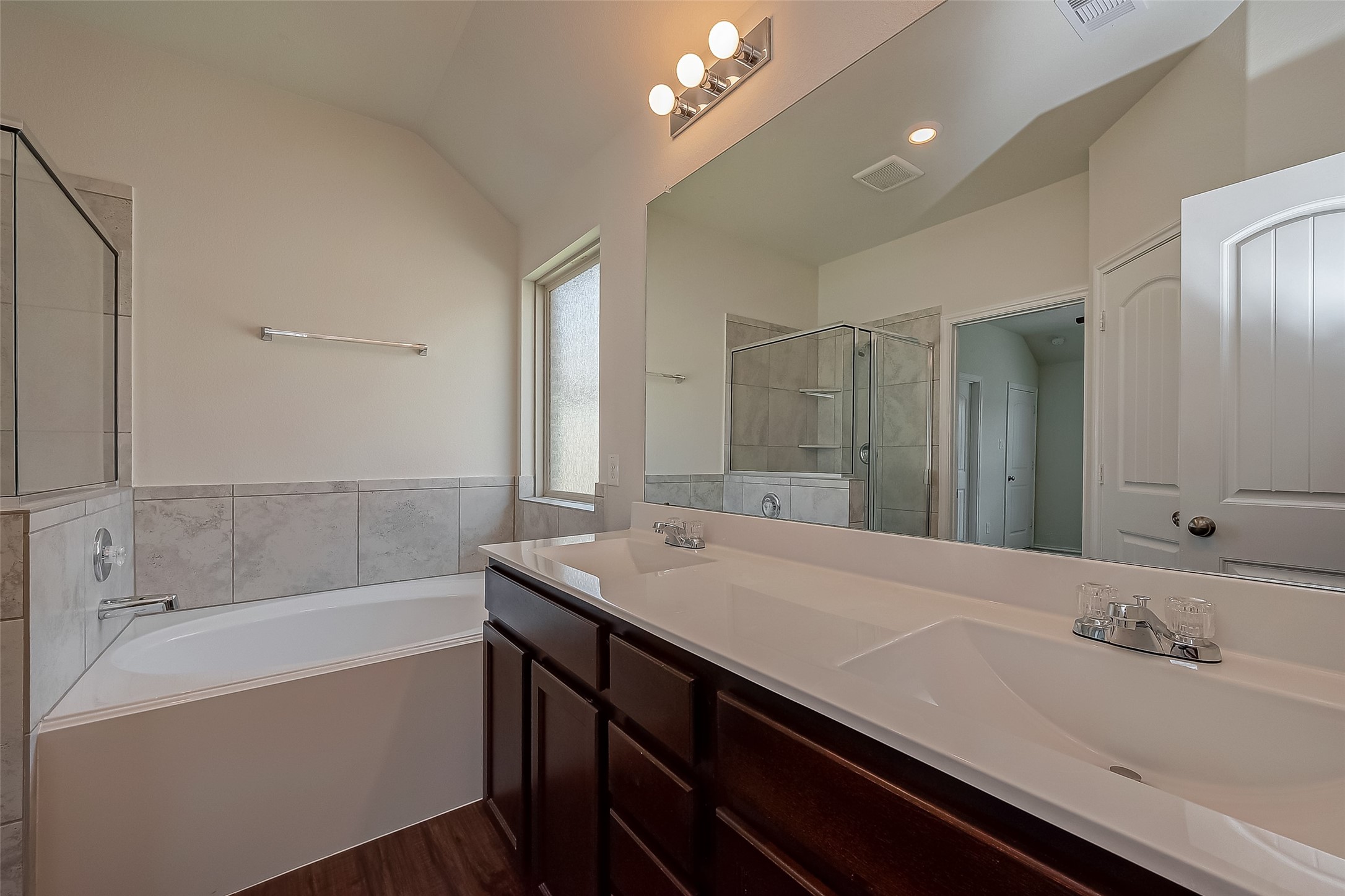 25911 Rustical Road Katy, TX 77493 - Photo 31 of 40 a bathroom with a sink a large mirror and a bathtub