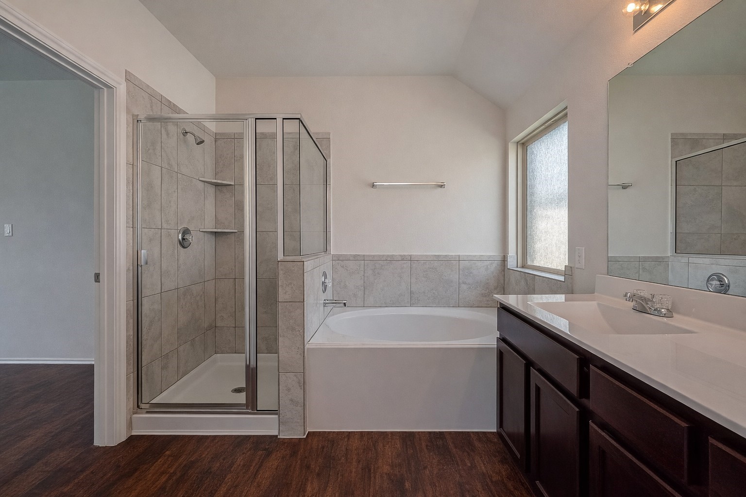 25911 Rustical Road Katy, TX 77493 - Photo 32 of 40 a bathroom with a shower sink vanity and mirror