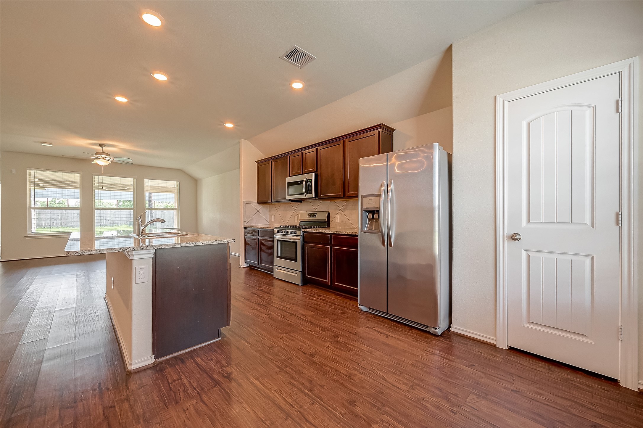 25911 Rustical Road Katy, TX 77493 - Photo 6 of 40 a kitchen with stainless steel appliances granite countertop a refrigerator microwave and stove