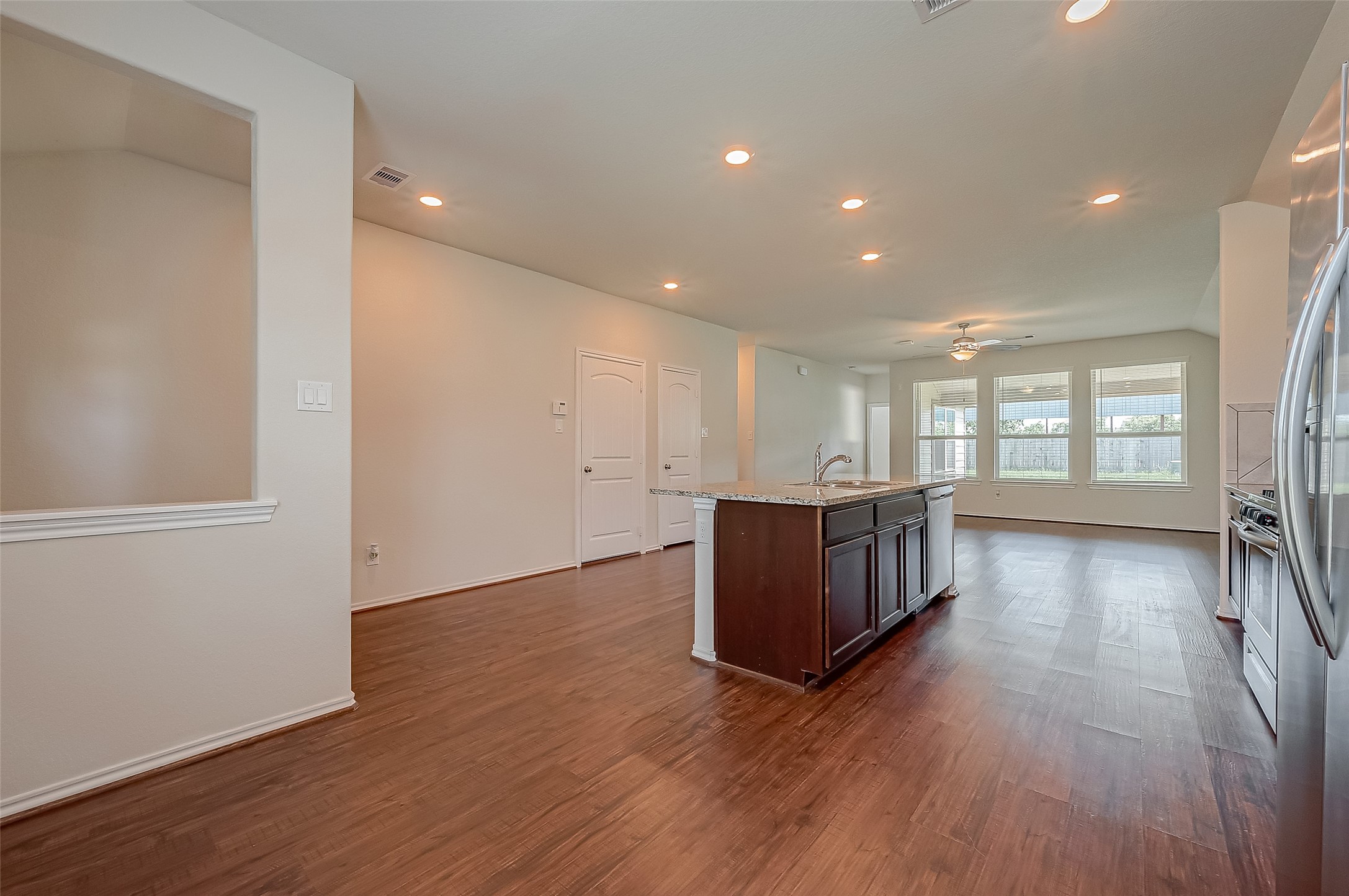 25911 Rustical Road Katy, TX 77493 - Photo 7 of 40 a view of an empty room with wooden floor and a window