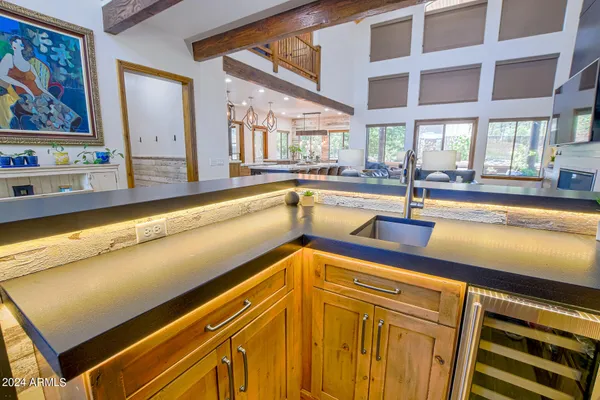 a kitchen with stainless steel appliances granite countertop a stove a sink and a refrigerator