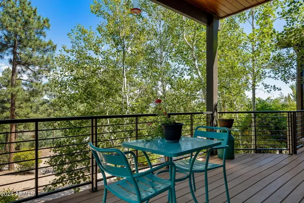 a view of a patio with chairs and plants