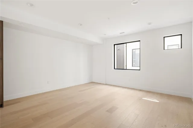 an empty room with windows and closet