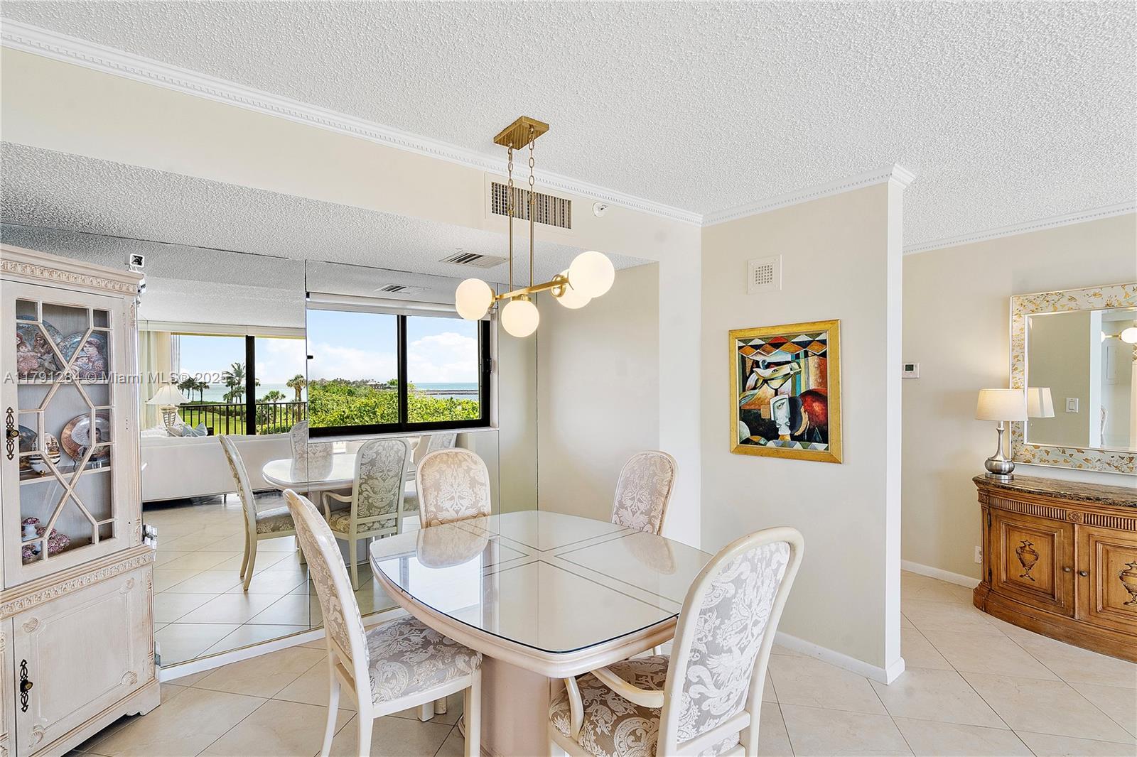 400 Ocean Trail Way, Unit 302 Jupiter, FL 33477 - Photo 12 of 34 a dining room with furniture a large window and a chandelier