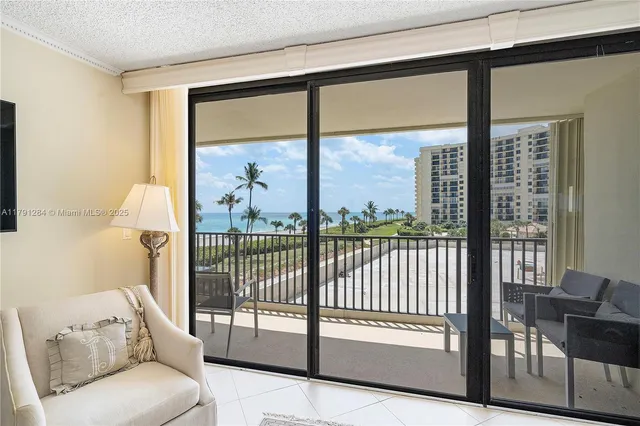 a view of a living room and floor to ceiling window