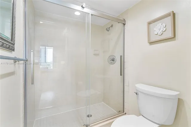 a bathroom with a toilet and shower