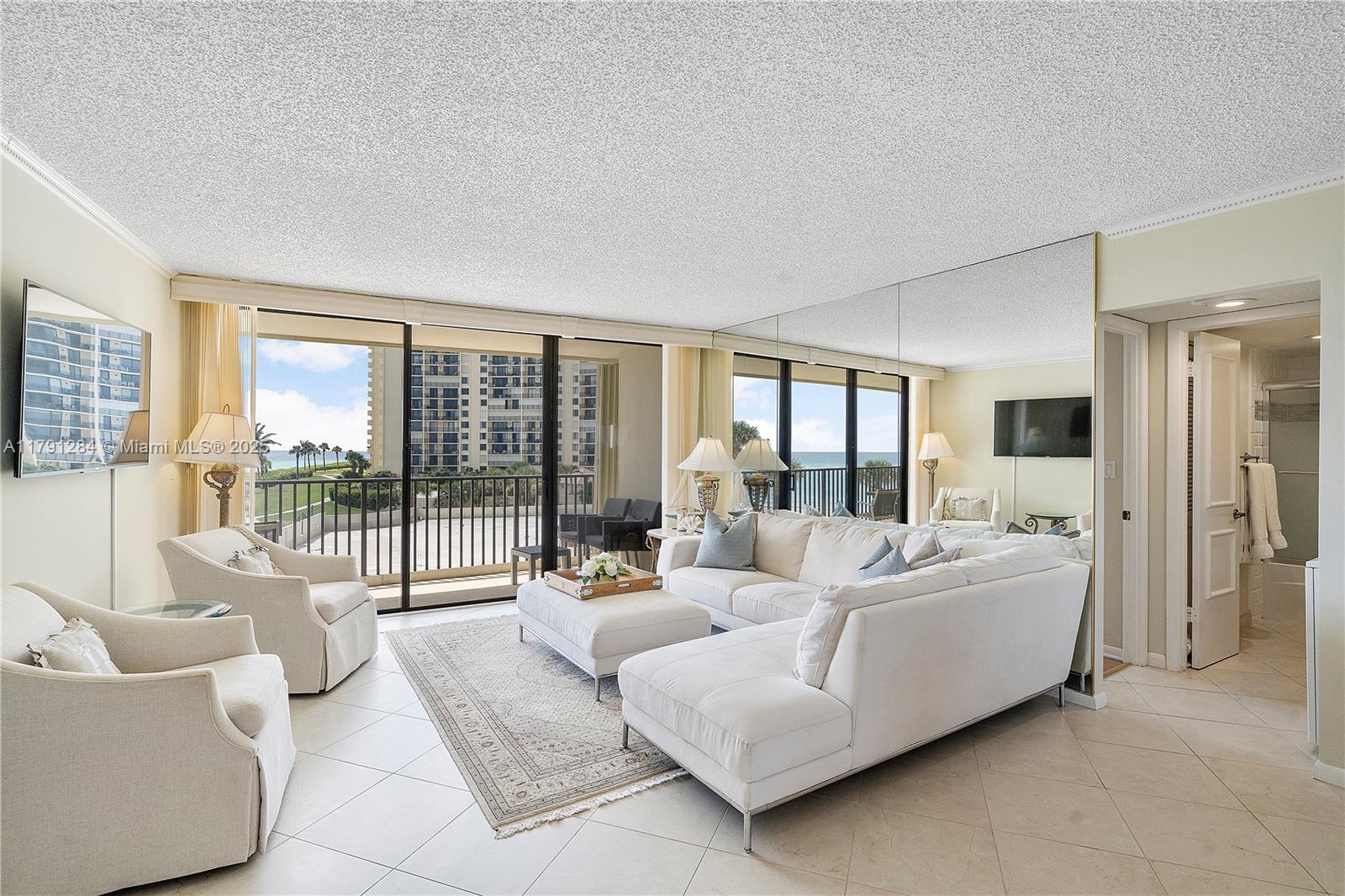 400 Ocean Trail Way, Unit 302 Jupiter, FL 33477 - Photo 5 of 34 a living room with furniture and a large window with balcony view