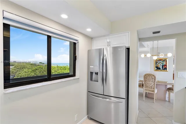 a metallic refrigerator sitting in a kitchen