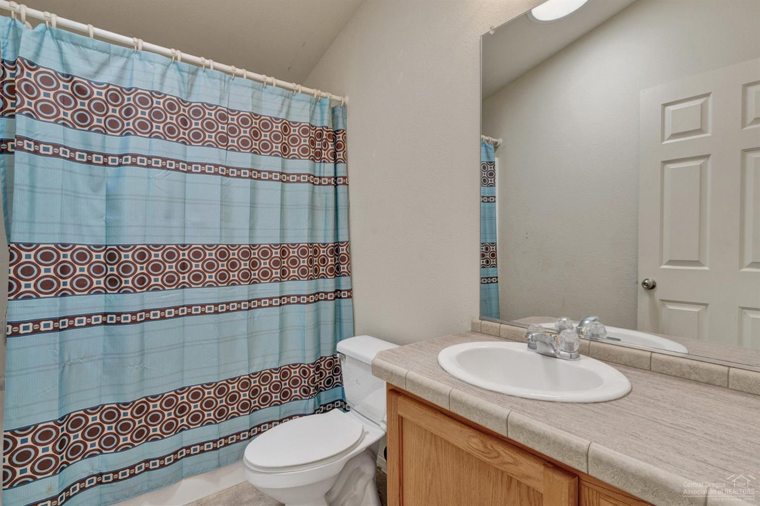 67252 Gist Road Bend, OR 97703 - Photo 17 of 24 a bathroom with a sink toilet and shower
