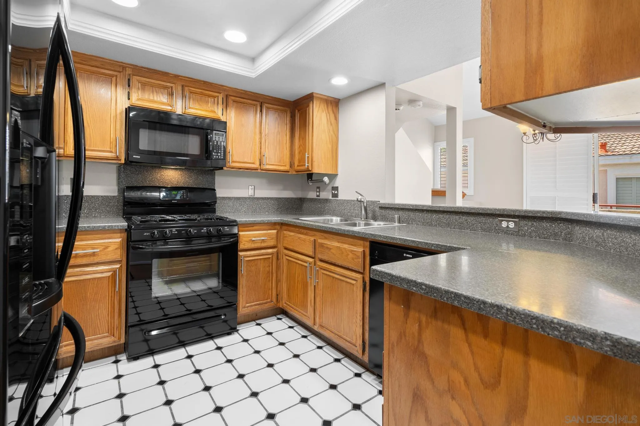 9338 Babauta Road, Unit 78 San Diego, CA 92129 - Photo 6 of 26 a kitchen with stainless steel appliances a stove a sink and a microwave