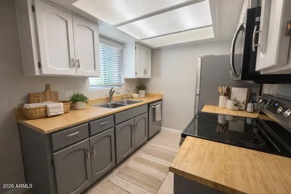 a kitchen with stainless steel appliances granite countertop a sink stove and cabinets
