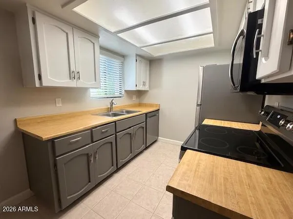 a kitchen with a sink and a stove